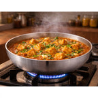 Hindalium aluminium kadai without handle placed on kitchen countertop, polished aluminium cooking vessel.